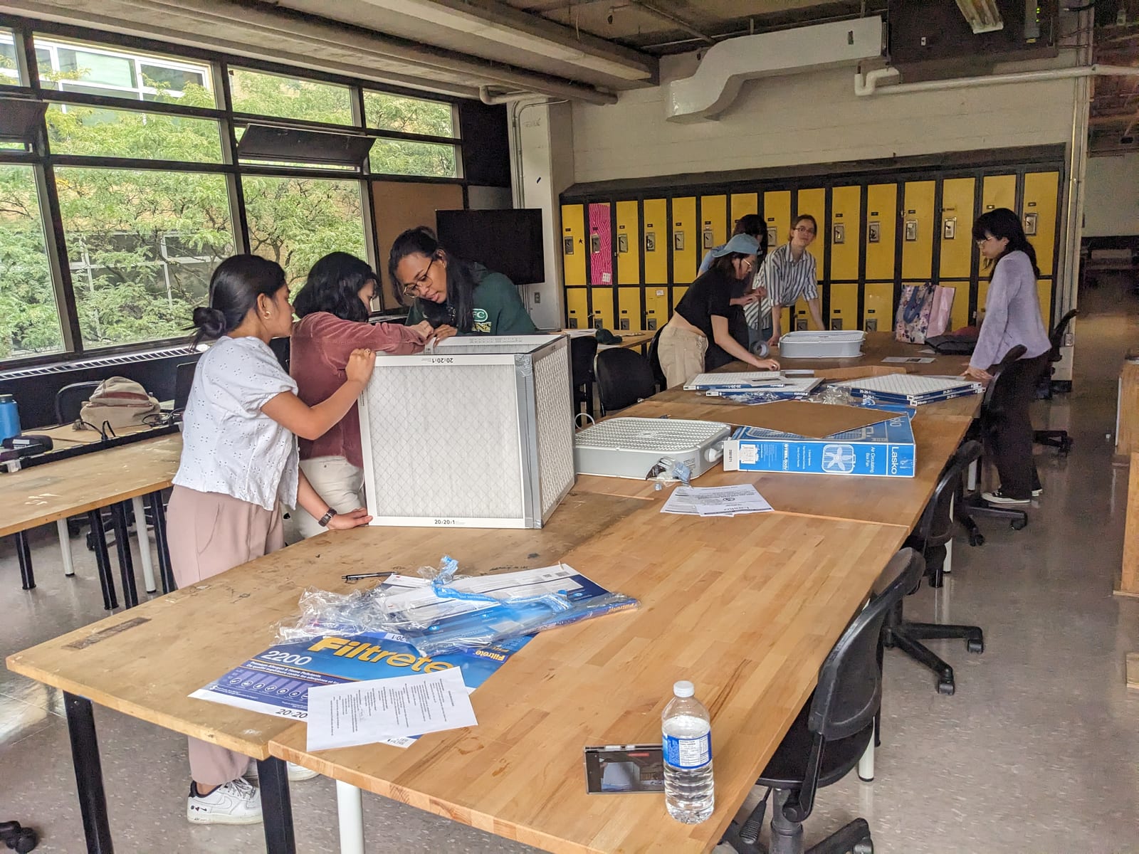 Students assembling box-fan air cleaners