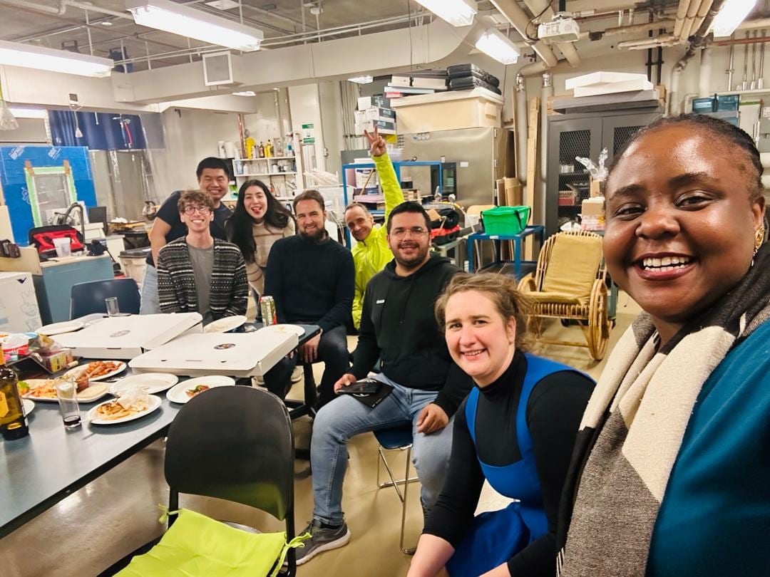 Lab members gathered around a table during a lab social