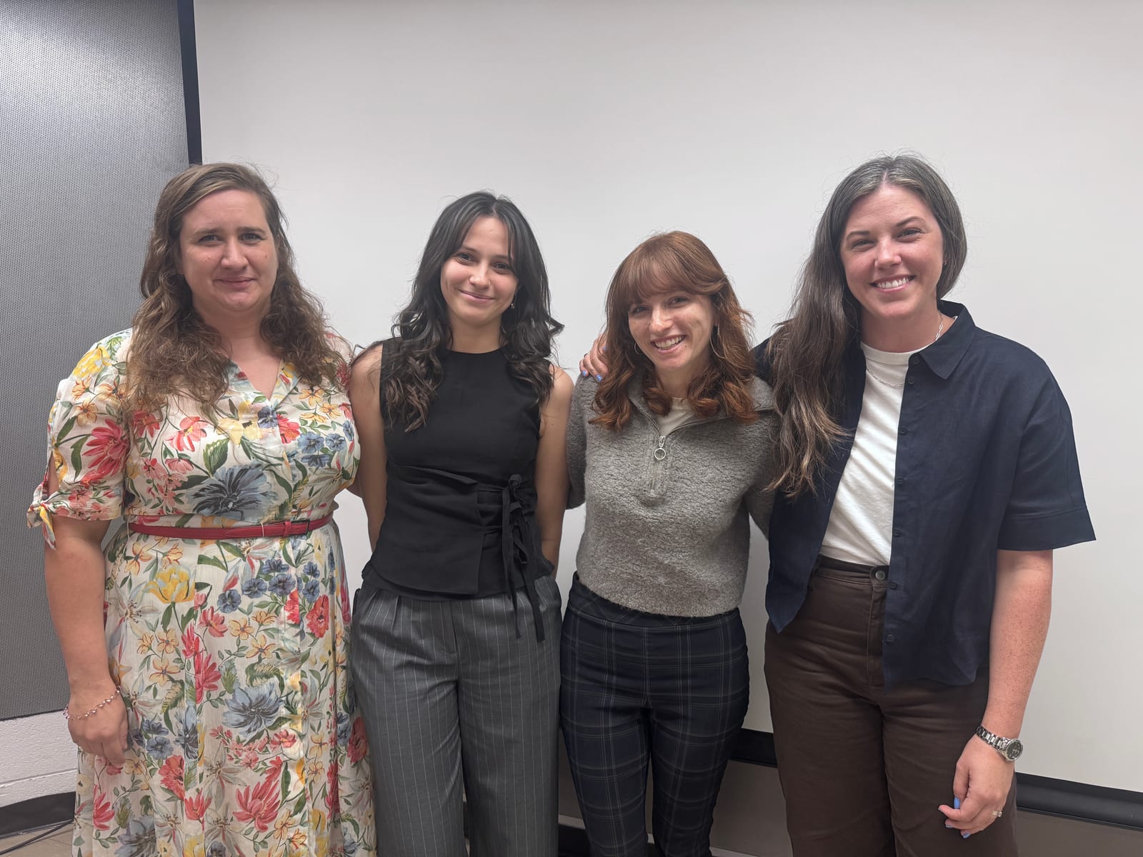 Four researchers celebrating a student milestone
