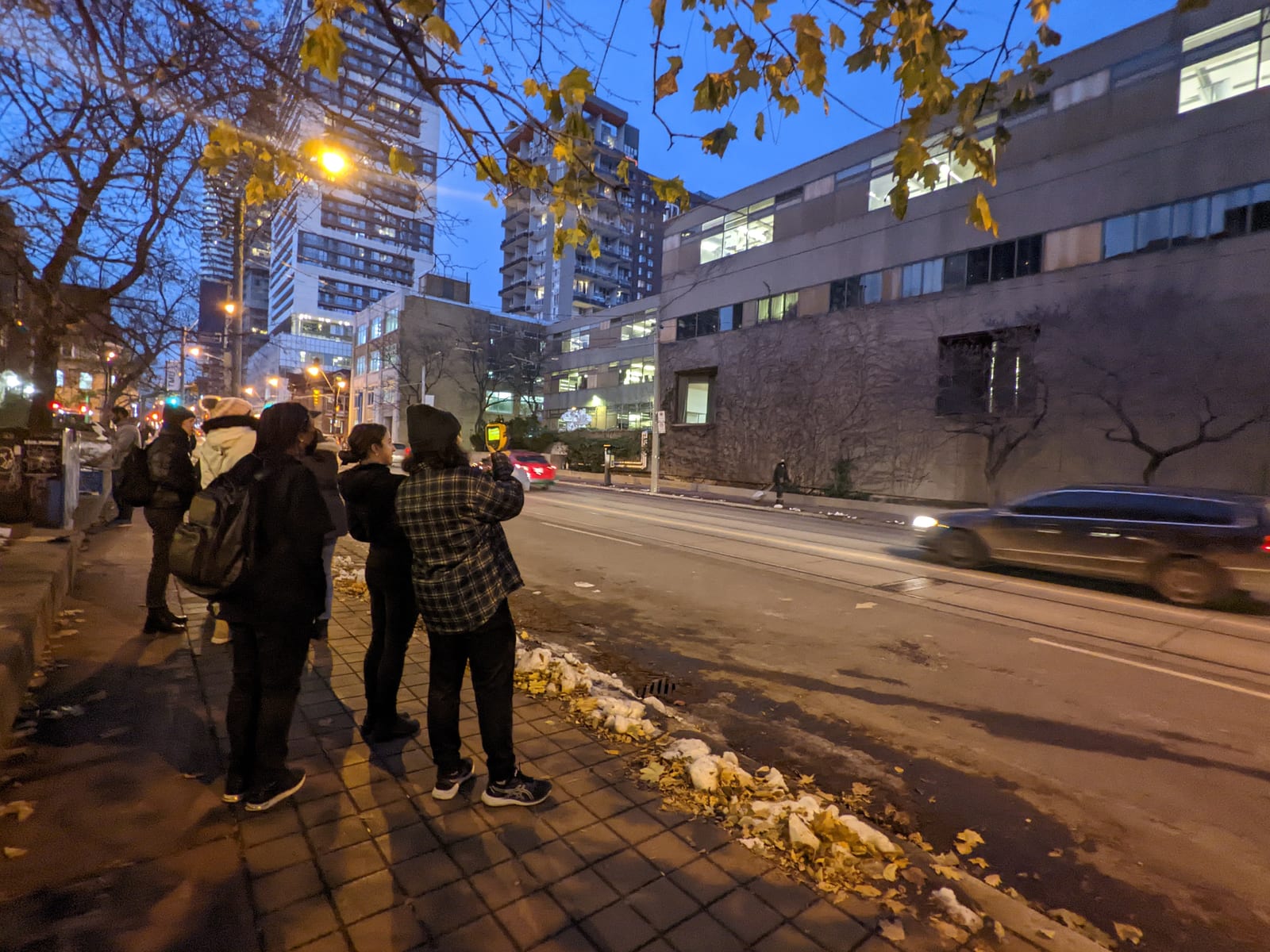 A group using a thermal camera during an evening building walk