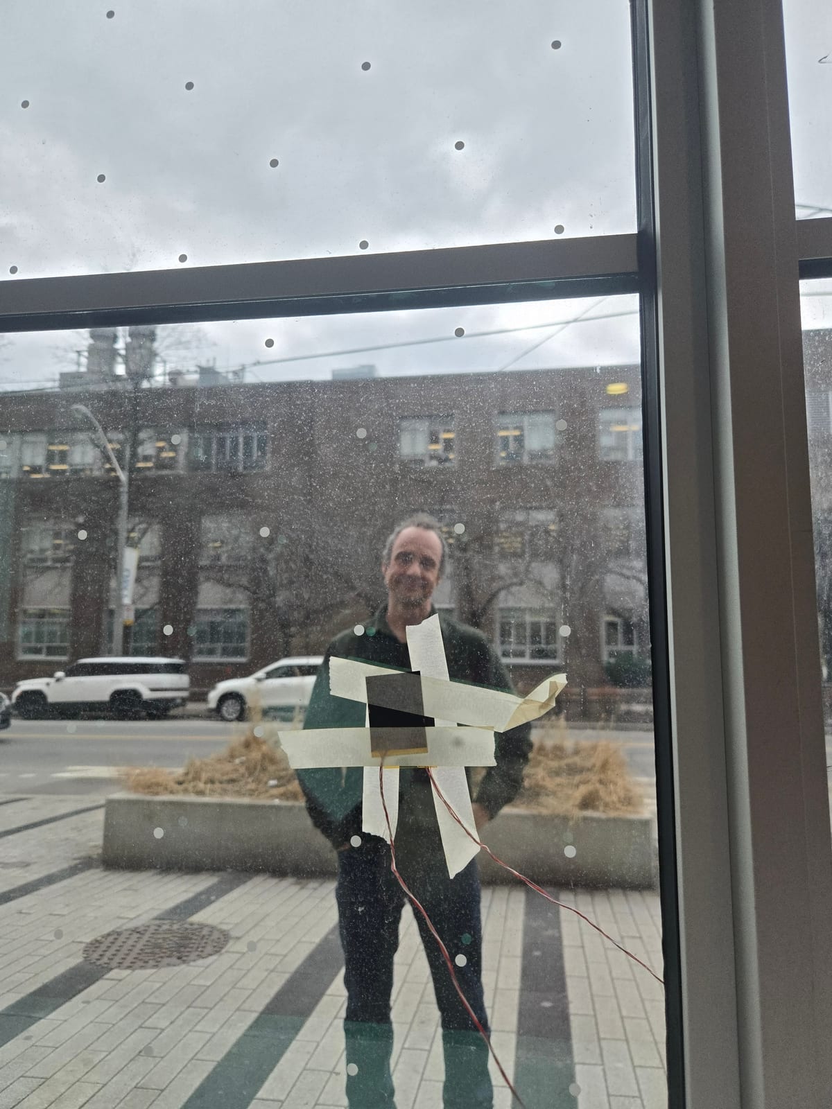 An improvised test assembly being held against a lab window