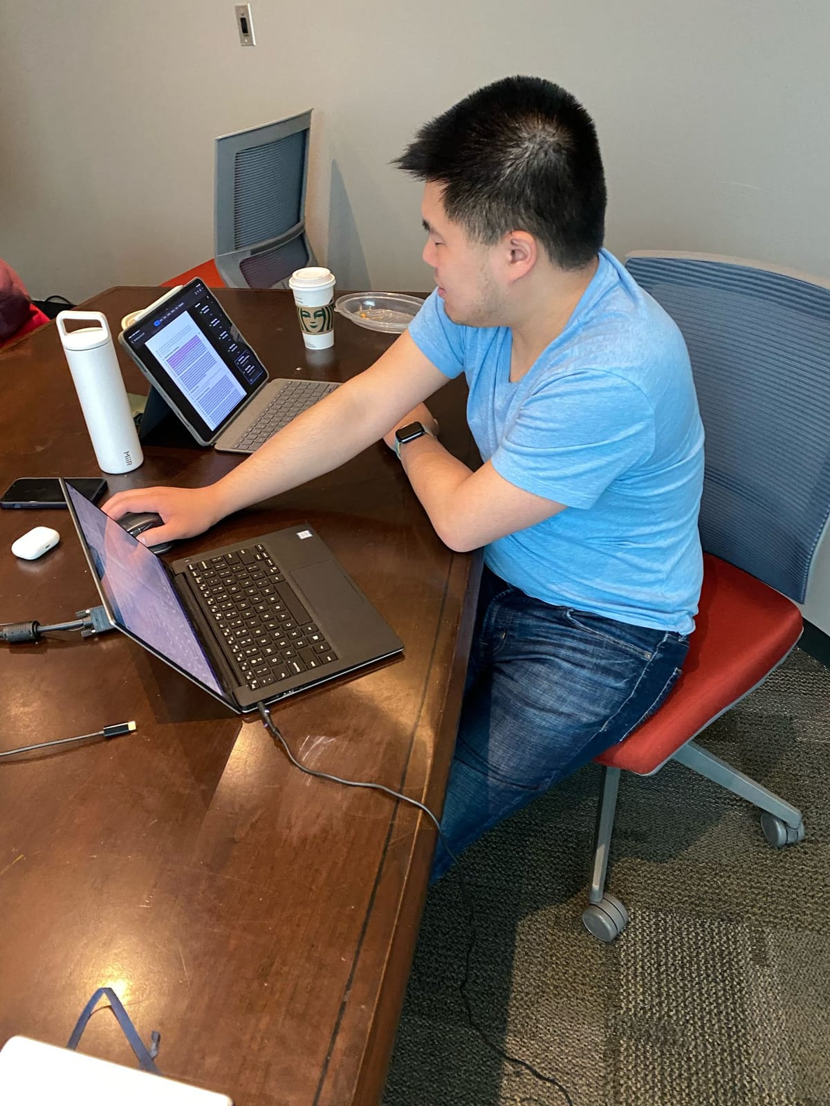 Michael working with a laptop and tablet